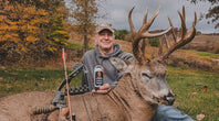 Hunter holding lotion with deer and bow